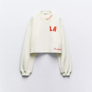 Varsity cream plush cropped sweatshirt Los Angeles CA embroidered red text